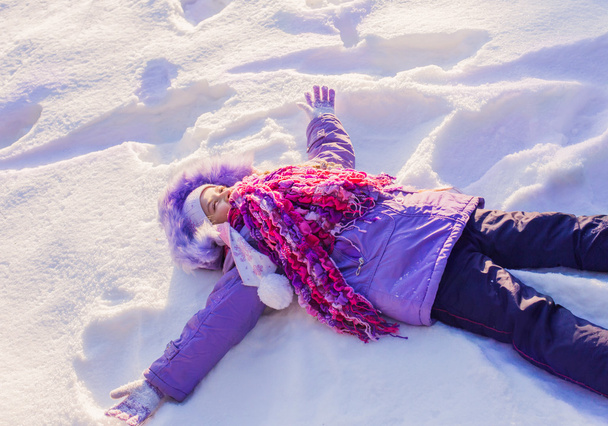 happy child in a clear white snow - 写真・画像