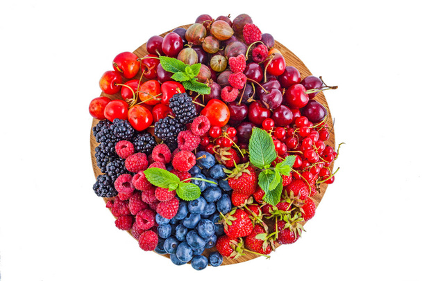Fresh summer berries assortment on the round plate - Photo, Image