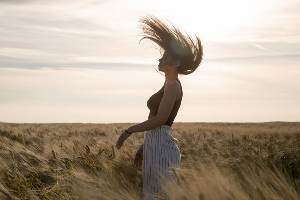 Portrait of a beautiful teenage girl with long hair on the meadow - Fotoğraf, Görsel