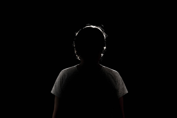 a dark black background with silhouette of male woman - Foto, Bild