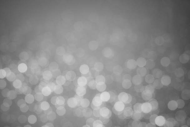A black-and-white image of bokeh from a blurred lens for the background of your project. - Foto, Imagem