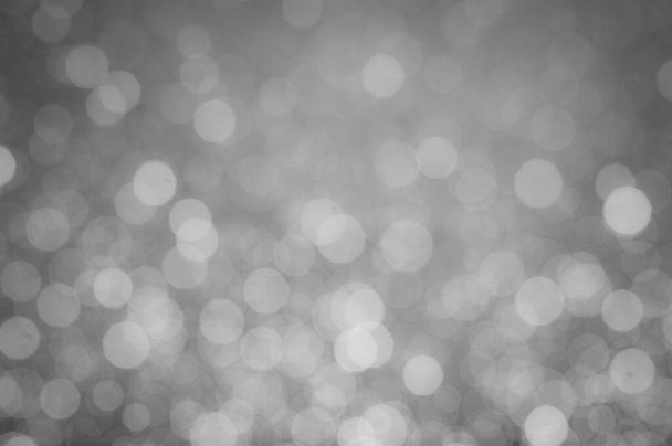 A black-and-white image of bokeh from a blurred lens for the background of your project. - Foto, Imagem