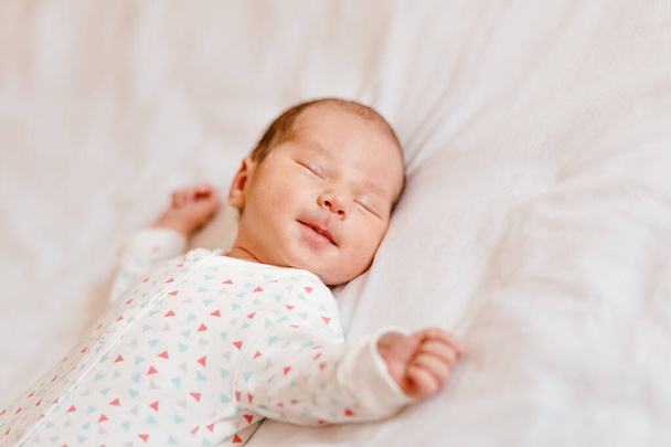 Newborn baby sleeps sweetly on a white plaid. Newborn photo shoot - Valokuva, kuva