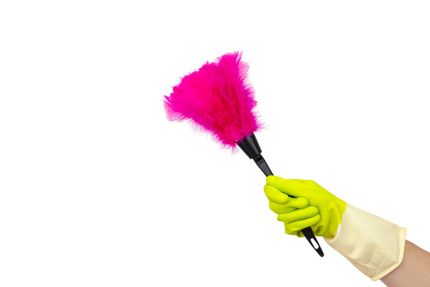 Cleaning supplies concept. Hand with soft magenta duster, synthetic feather broom isolate on white. Cleaning concept, cleaning service - Fotoğraf, Görsel