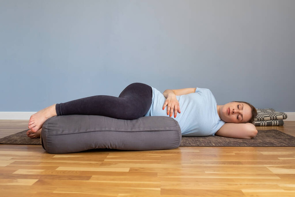 Pregnant woman lying in Shavasana, resting after practice, meditating - Photo, image
