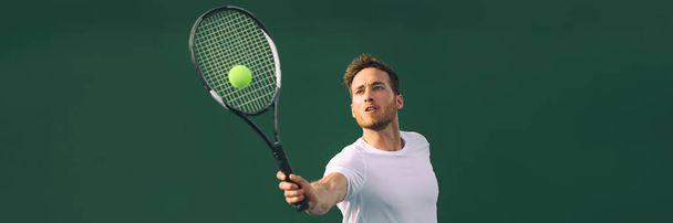 Tennis player man hitting ball playing tennis match on outdoor hard court in fitness club. Male sport athlete healthy lifestyle. Banner crop with copy space - Photo, Image