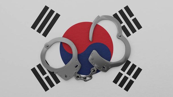 Menottes en acier à moitié ouvertes au centre et au-dessus du drapeau national de la Corée du Sud - Photo, image