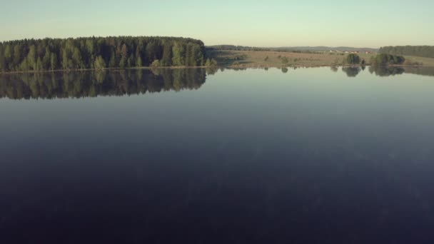Muž rybaří na dřevěném molu u jezera - Záběry, video