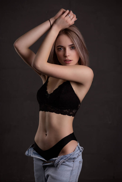 Young beautiful girl in sexy underwear, on a dark background - Zdjęcie, obraz