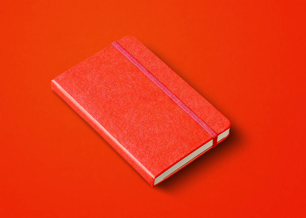 Red closed notebook mockup isolated on color background - Foto, Imagen