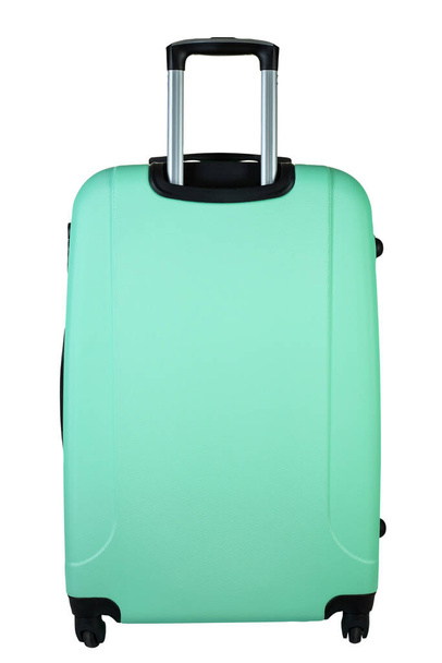 Plastic suitcase turquoise color on wheels for travel. Travel concept. File contains clipping path. - Foto, afbeelding