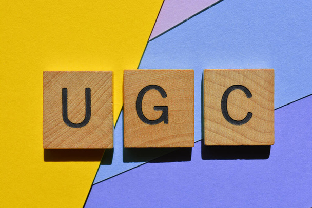 UGC, acronym for User Generated Content, in wooden alphabet letters isolated as banner headline  - Photo, Image