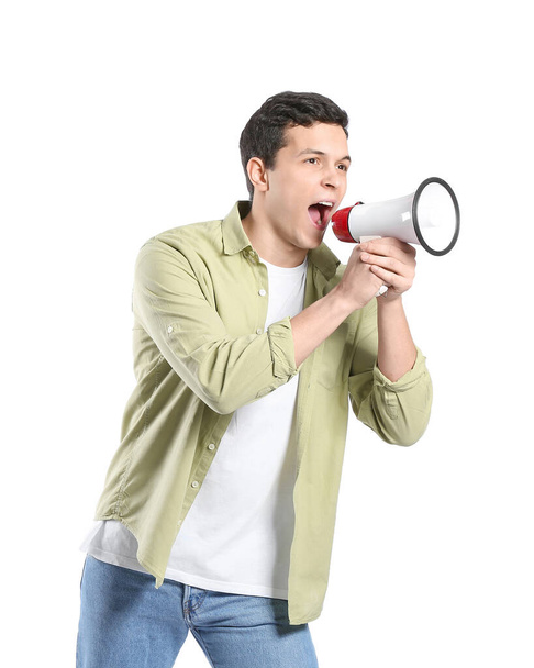 Handsome young man shouting into megaphone on white background - Foto, Bild