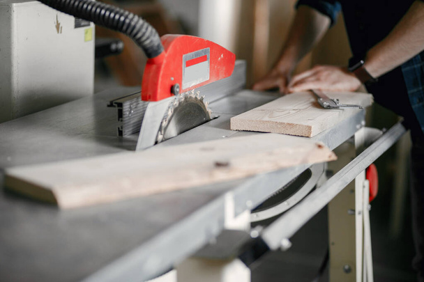 Carpenter working with circular saw - Фото, зображення