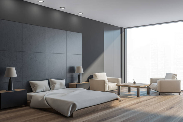 Dark bedroom interior with grey bed and pillows, side view, parquet floor and two armchairs with coffee table. Mockup copy space in sleeping room with city view, 3D rendering - Foto, Bild