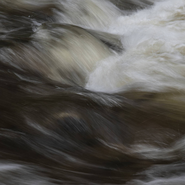 Hermosa imagen de paisaje de bellas artes de larga exposición detalle de agua que fluye rápido sobre rocas en el río - Foto, Imagen