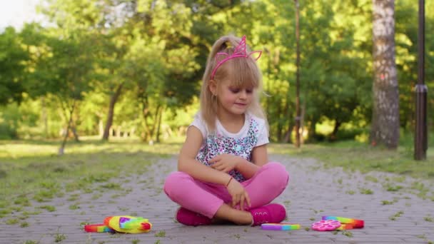 Lapsi tyttö lapsi pelaa push pop se kupla purista fidget aistien leluja, stressi ahdistuneisuus helpotus peli - Materiaali, video