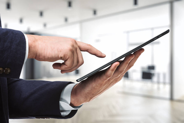 Businessman hand clicks on the screen of a digital tablet in conference room, close up. Internet Work Concept - Fotoğraf, Görsel