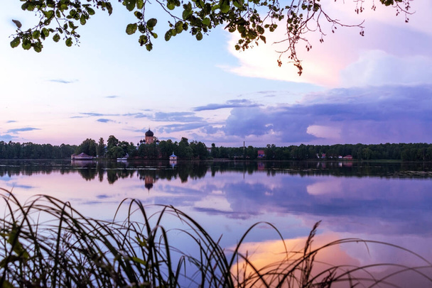 Sunset over lake. Reflection in the lake water. Vvedensky Monastery. Pokrov. Vladimir region. Russia - Fotoğraf, Görsel