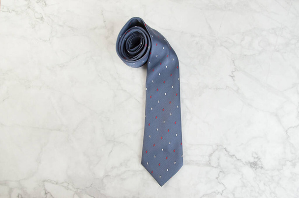 Gray neck tie on marble background. Copy space for text. - Photo, Image
