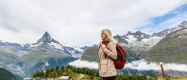 woman looking at the beautiful Mount Matterhorn in the Swiss Alps - Photo, Image
