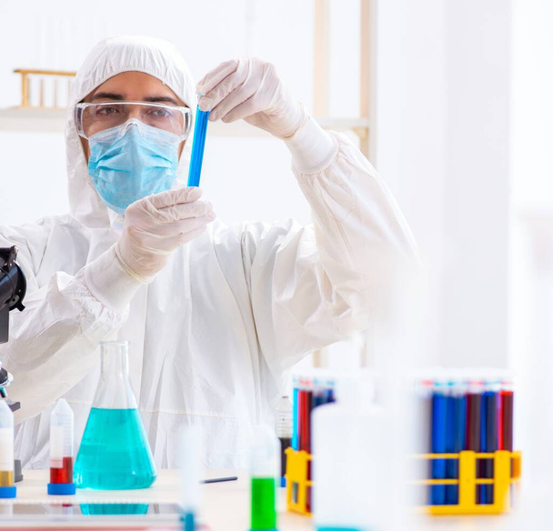 Young chemist student working in lab on chemicals - Photo, Image