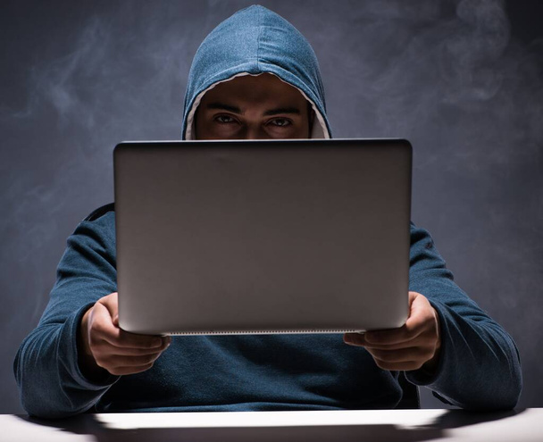 Computer hacker working in dark room - Photo, Image