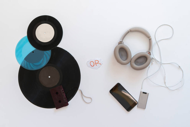 an analog versus digital music, headphones and vinyl cassette flat lay - Foto, imagen