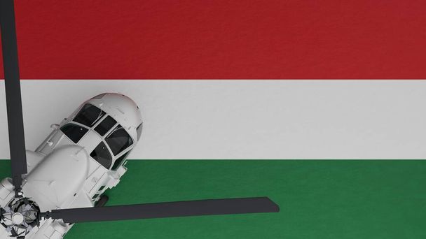 Vista de arriba hacia abajo de un helicóptero blanco en la esquina inferior izquierda y en la parte superior de la bandera nacional de Hungría - Foto, Imagen