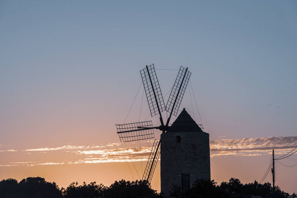 Silhouettes of the mill of Jeroni, Sa Miranda on the island of Formentera in Spain. - Photo, Image