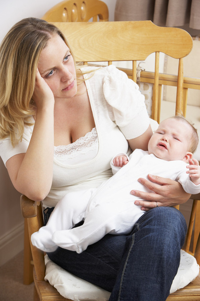 Worried Mother Holding Baby In Nursery - Фото, изображение