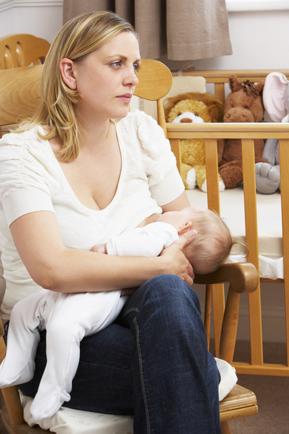 Worried Mother Breastfeeding Baby In Nursery - Фото, изображение