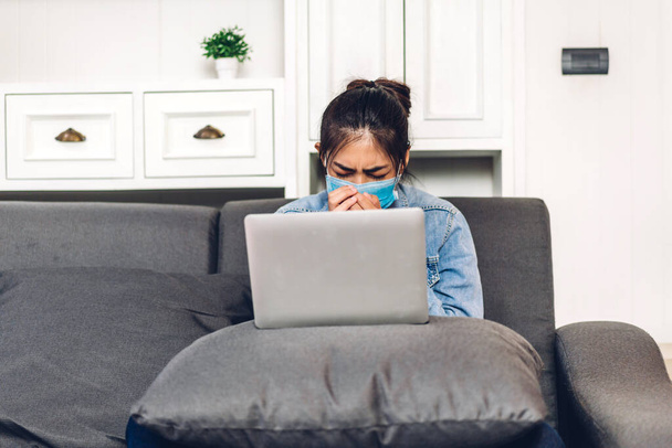 Fiatal ázsiai nő használ laptop számítógép munka és videó konferencia találkozó online chat karanténban a koronavírus visel védő maszk otthon.work from home koncepció - Fotó, kép