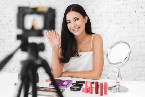 Smiling of cheerful pretty woman beauty clean fresh healthy white skin blogger in front of camera recording vlog herself talking with makeup cosmetic for internet social network at home - Photo, image