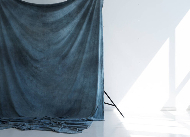 blue studio fabric background on racks - Fotó, kép