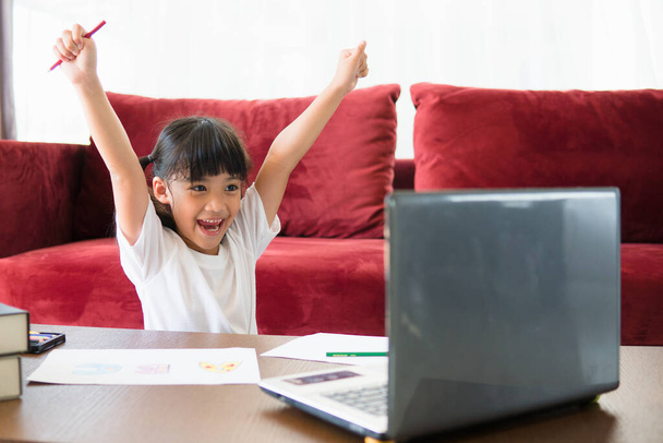 Asiatique fille étudiant en ligne classe d'apprentissage étude en ligne avec ordinateur portable à la maison. - Photo, image