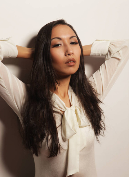 Beautiful young asian woman model with long hair posing in fashionable white dress - Fotografie, Obrázek