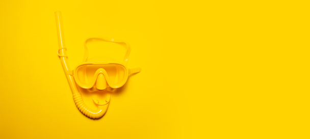 Panoramic banner view of yellow diving mask with snorkel, isolated on yellow background with copy space. - Photo, image