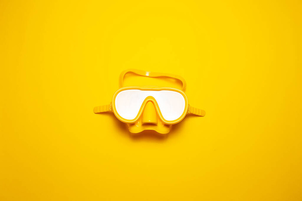 Top view of yellow diving mask isolated on yellow background. - Photo, image