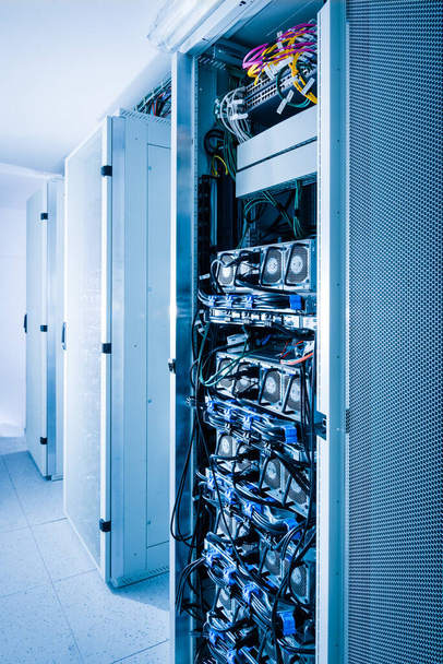 A row of racks with data storage hardware inside server room - Valokuva, kuva