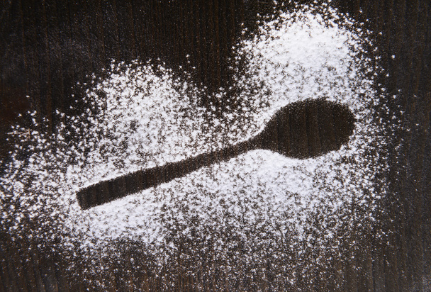 Imprint spoon made of flour on table close-up  - Foto, Bild