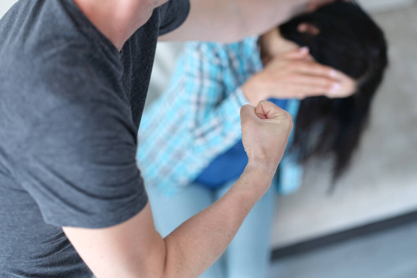Angry aggressive man punches woman at home closeup - Photo, Image