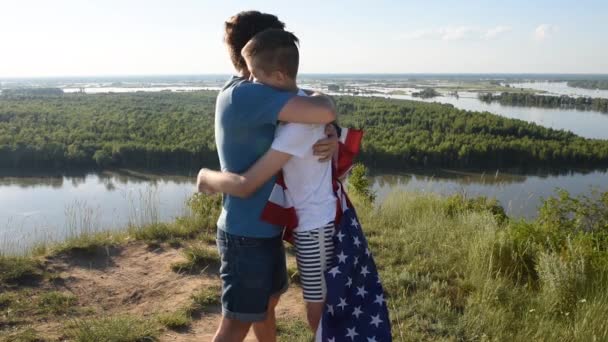 Cute young boy and his father holding aloft the American flag - Footage, Video