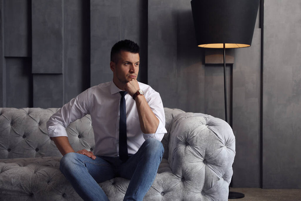 Handsome businessman on sofa indoors. Luxury lifestyle - Foto, imagen