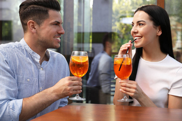 Pareja feliz con Aperol spritz cocktails al aire libre - Foto, imagen