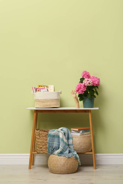 Console table with beautiful hortensia flower near light green wall in hallway. Interior design - Fotografie, Obrázek