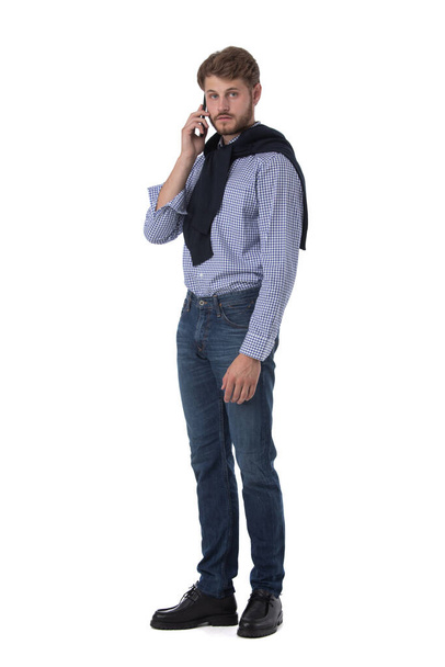 Full length Portrait of handsome young man using mobile phone, isolated on white background - Zdjęcie, obraz