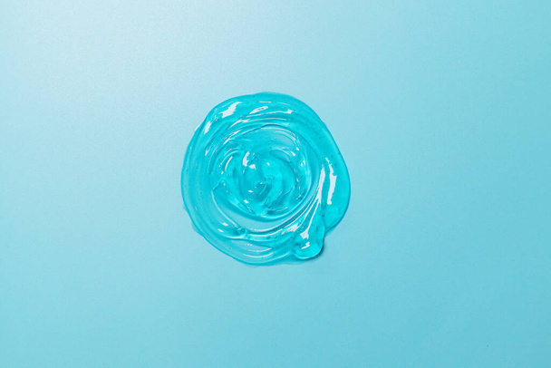 Liquid gel cosmetic drops texture blue grey background - 写真・画像