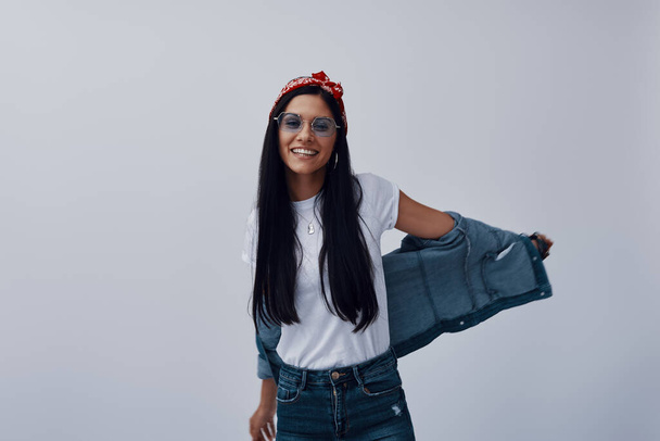 Funky young woman in bandana looking at camera and smiling - Foto, afbeelding