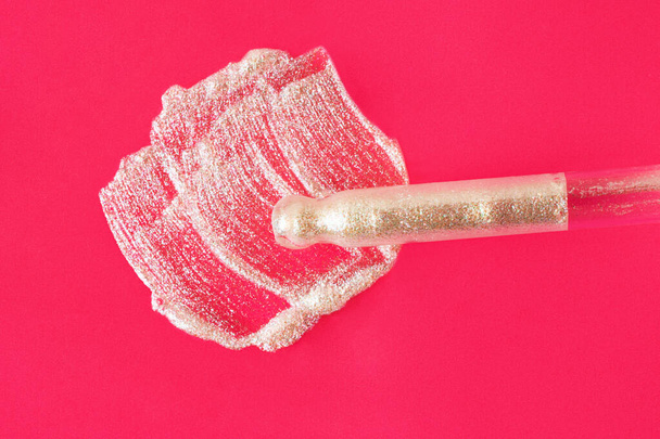 Holographic cosmetic smear on the bright pink background with pipette from dropper near it. - Photo, Image